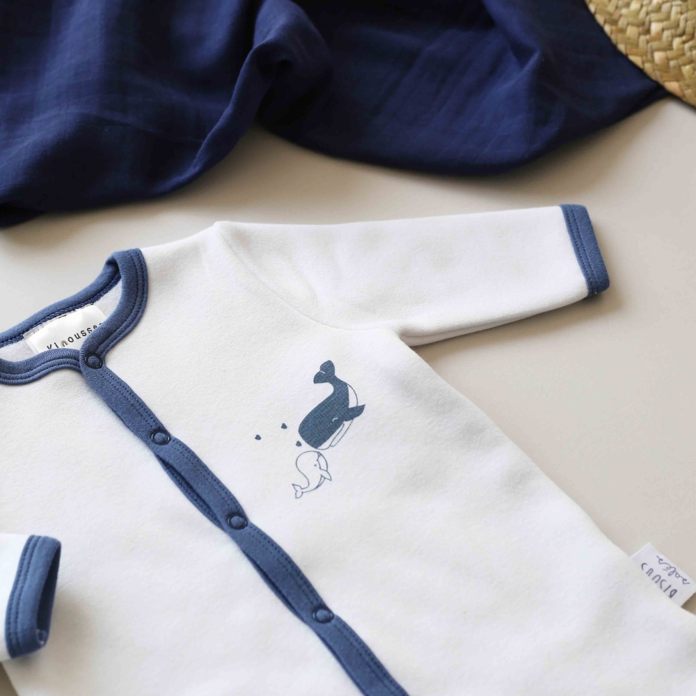 Zoom sobre el motivo del pelele y gasa azul marino de fondo