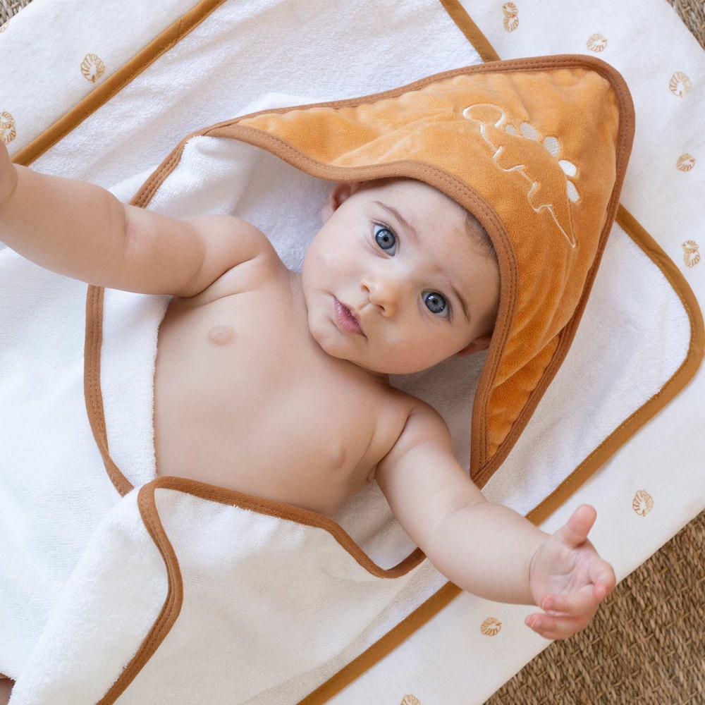 Baby snug in their camel hooded bath towel