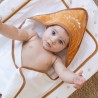 Baby snug in their camel hooded bath towel