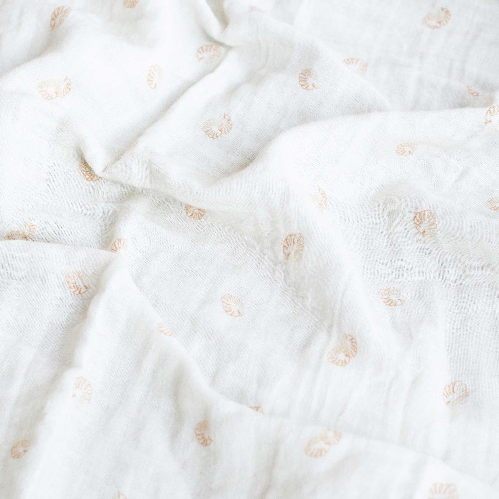 Ecru swaddle with terracotta leaf patterns Ecru swaddle with terracotta leaf patterns