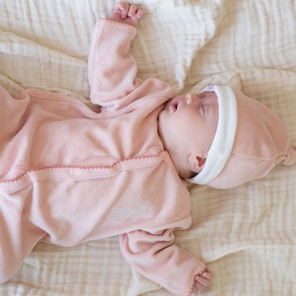 Baby sleeping in Sophie the giraffe pink pajama and pink hat Baby sleeping in Sophie the giraffe pink pajama and pink hat