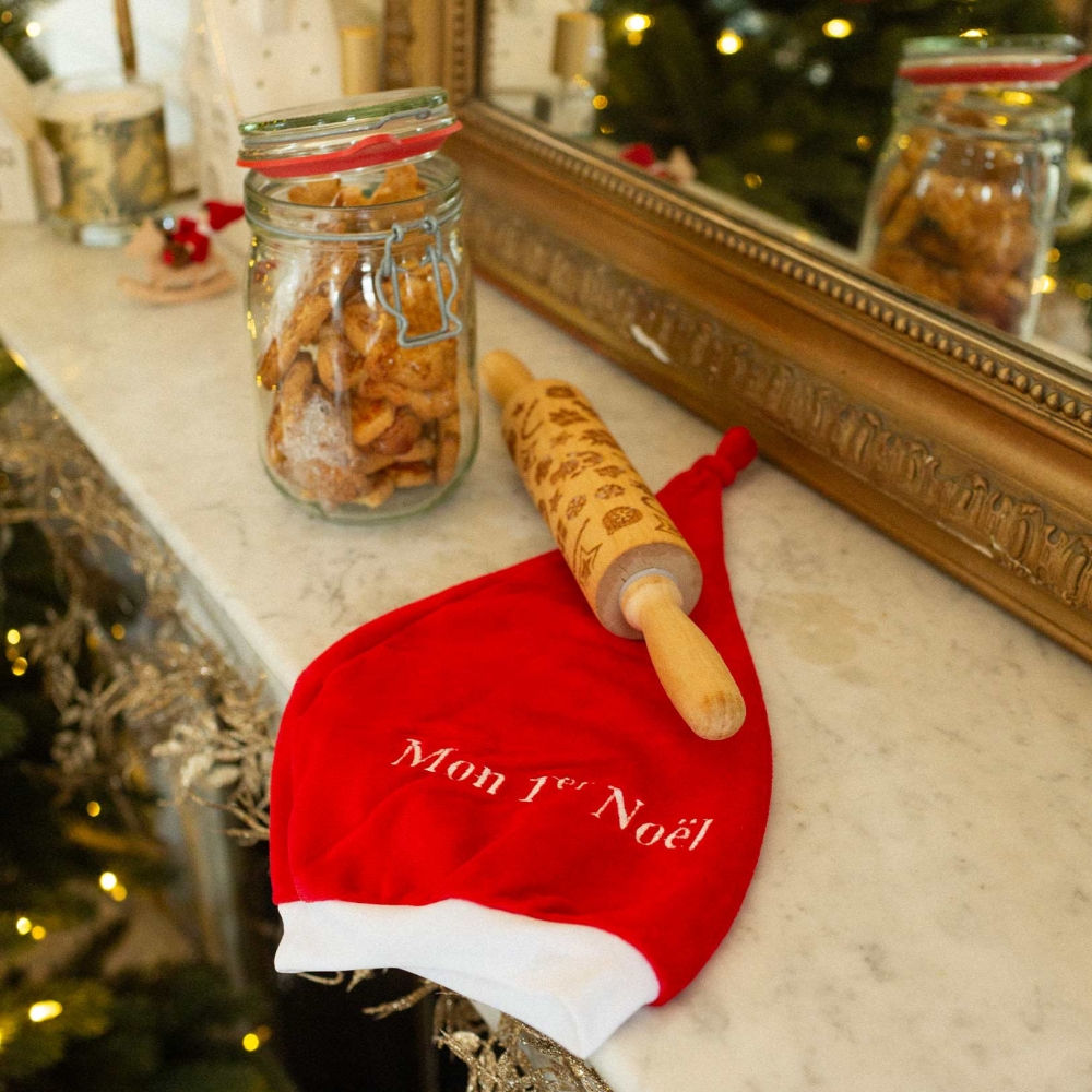 Baby christmas hat on the fireplace Baby christmas hat on the fireplace