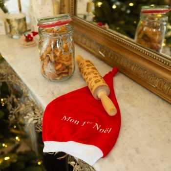 Gorro de navidad para bebé en la chimenea