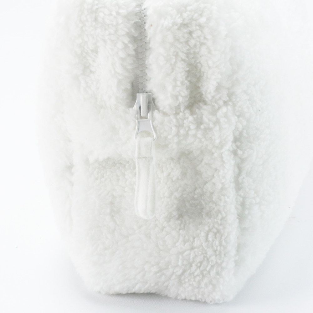 Zoom de material sherpa neceser bebé blanco