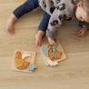Little girl playing with wooden puzzles