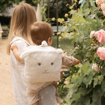 baby in mom's arms with backpack