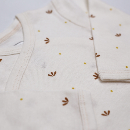 Beige baby bodysuit with flower petals