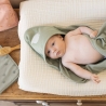 baby on changing mat with hooded bath towel baby on changing mat with hooded bath towel