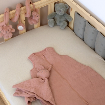 Baby sleep sack with developmental toys in crib