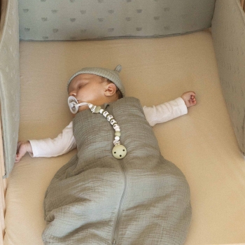 baby sleeping in muslin sleeping bag
