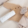 swaddle placed on baby changing mat with baby cardigan