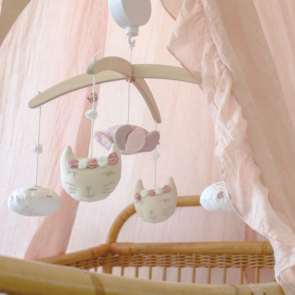 Musical mobile above the rattan bed