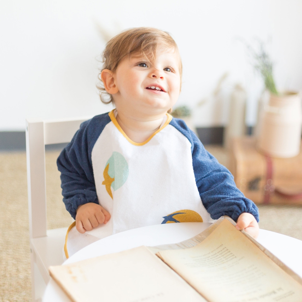 Smiling child with bib apron