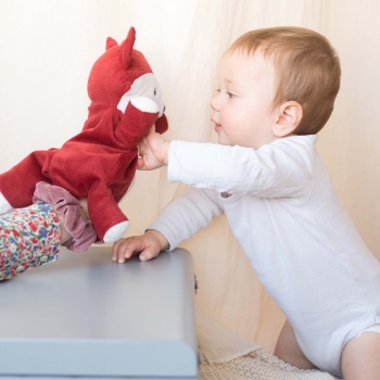 A mom playing puppet with Leonard the fox plush toy