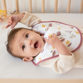 Pretty little happy girl with her flower bib