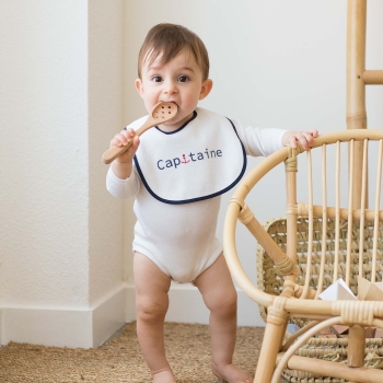 Little boy with first age bib