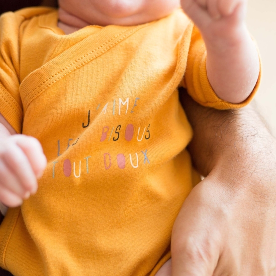 Set of two crossed mustard and white bodysuits