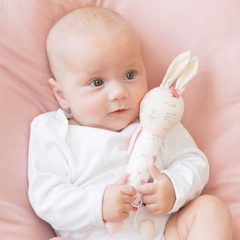 Little girl having fun with her Lili the rabbit musical stick