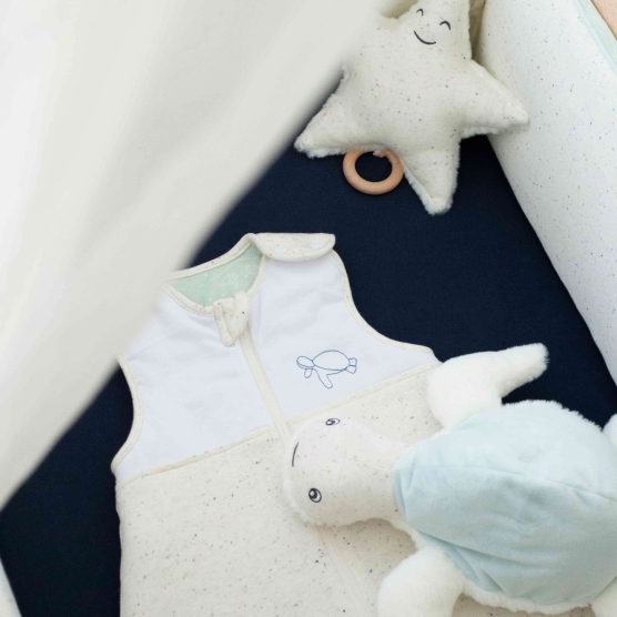 flecked sleeping bag with turtle embroidery on top