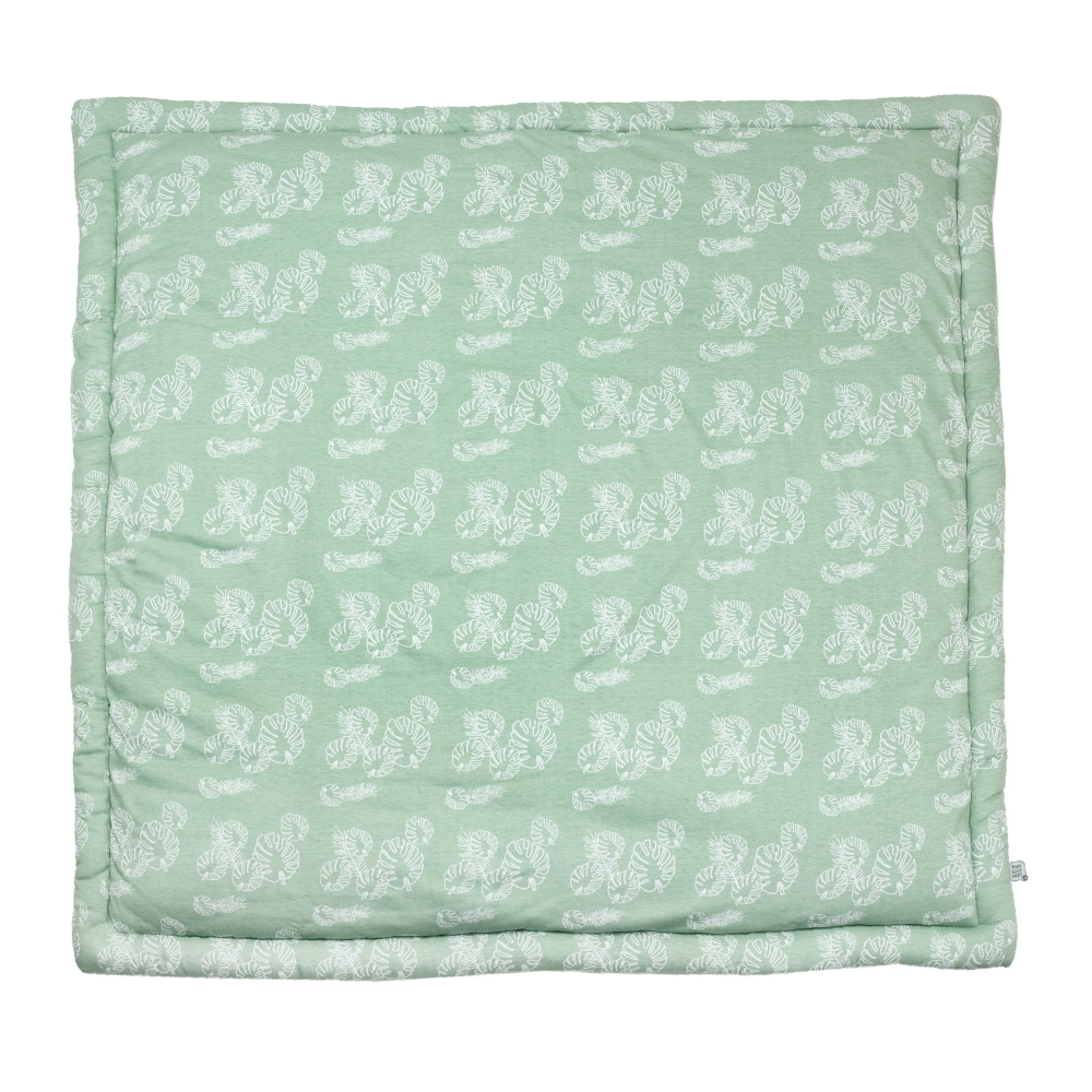 playpen mat with white leaf pattern on sage green background