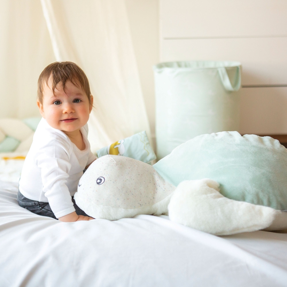 Baby with its large Manu the turtle plush toy Baby with its large Manu the turtle plush toy