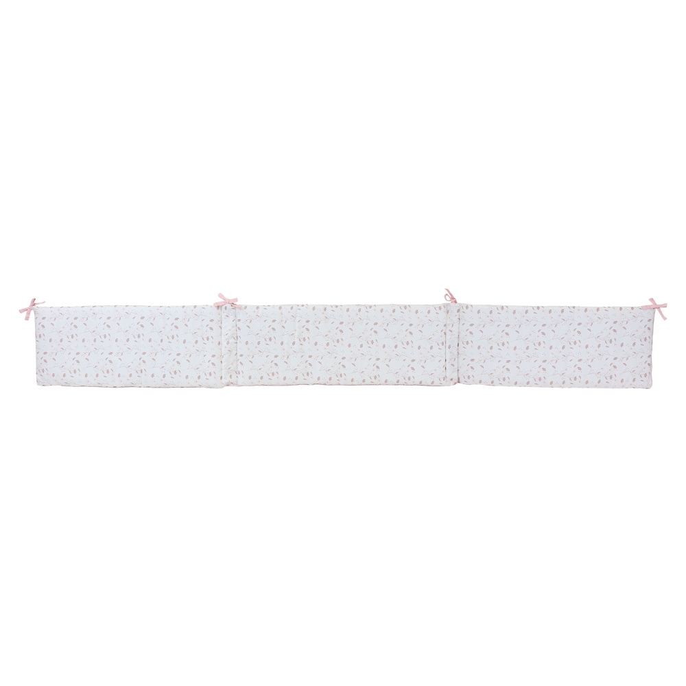 Crib bumper unfolded to clearly show its attachments and length. Crib bumper unfolded to clearly show its attachments and length.