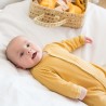 baby in mustard ribbed pajamas
