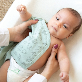 Baby on changing mat with short-sleeved bodysuit