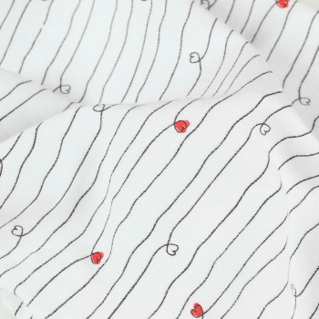 close-up of navy blue stripes and red heart on unisex baby bodysuit