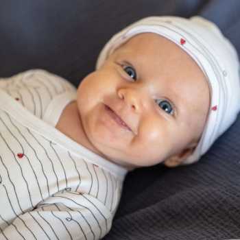 long-sleeved bodysuit on a smiling baby