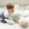 Baby playing with their big soft plush turtle toy Baby playing with their big soft plush turtle toy