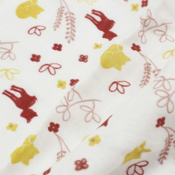 Close-up of the forest pattern on the swaddle blanket with the fox and small leaves
