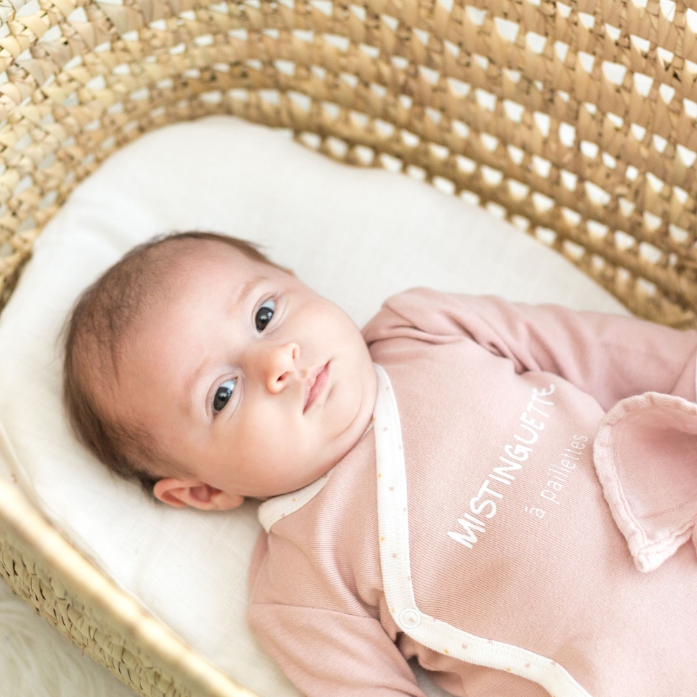 Baby girl lying in her adorable "Mistinguette" cotton bodysuit Baby girl lying in her adorable "Mistinguette" cotton bodysuit